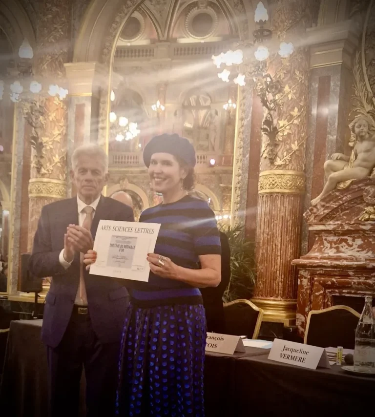 Crista holding certificate from French Academy
