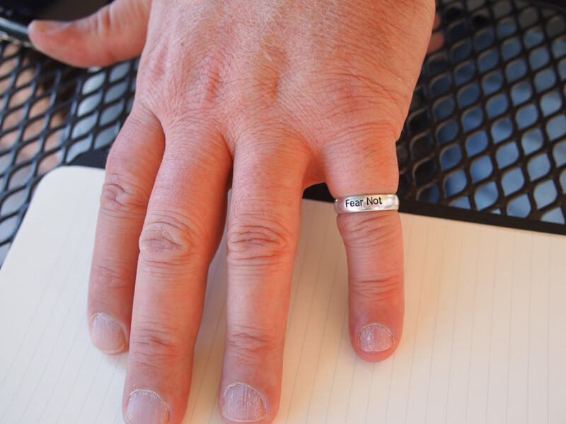 Photo of a hand with a "Fear Not" ring on the smallest finger