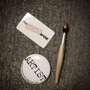 the working artist badge wirh card and brush
