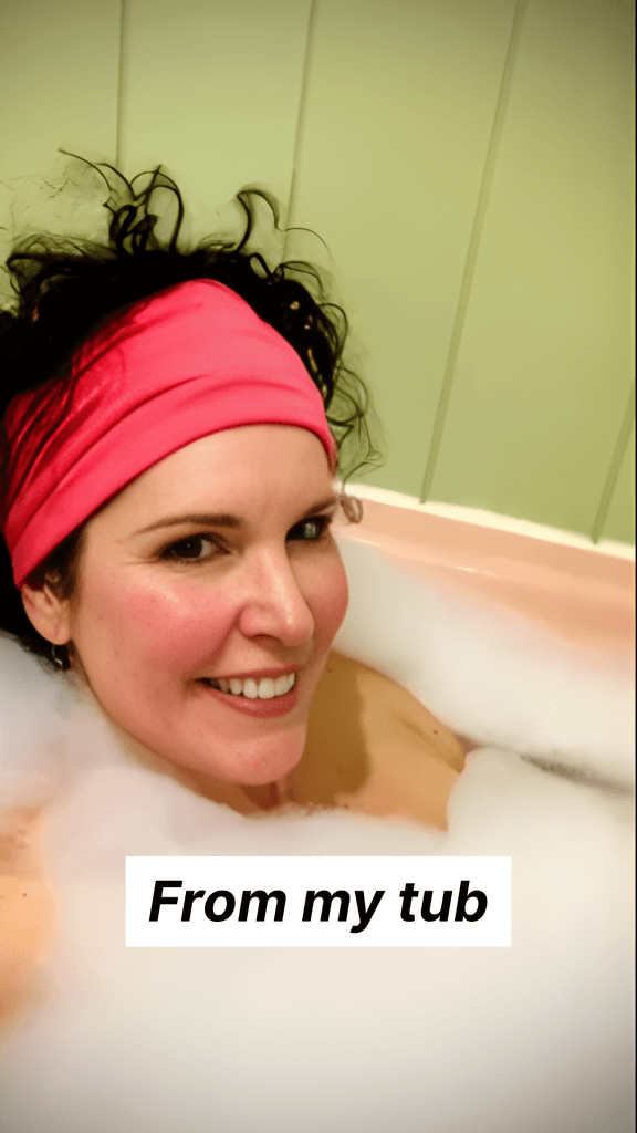 Crista in bathtub getting ready because in a few hours she will be hosting the Welcome Salon for the Working Artist Academy