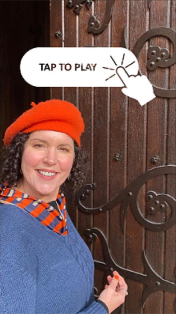 Crista slowly starts pushing one of the massive church doors shut while answering an artist coming toward asking about The Working Artist academy enrollment